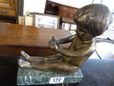 A brass figure of a cherub on plinth