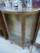 A bow fronted display cabinet