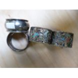 Two enamelled silver napkin rings and two others