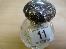 A silver topped scent bottle