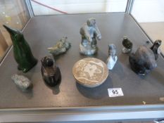 A quantity of Innuit carved figures etc. which includes an Eskimo innuit figure holding a knife,