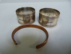 A Pair of hallmarked silver napkin rings - 50g and a Sabona copper bracelet