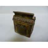 A Victorian era stamp box in the form of a U.S mail box, with badge to front depicting Washington