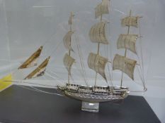 A silver model of a sailing ship in case. Small plaque to front stating "Silver 950"