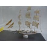 A silver model of a sailing ship in case. Small plaque to front stating "Silver 950"