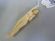 An early 20th century chinese carved ivory medical figure of a naked lady of traditional reclining