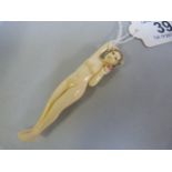 An early 20th century chinese carved ivory medical figure of a naked lady of traditional reclining