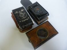 A Lantern case, Piccolette Camera in case and one other