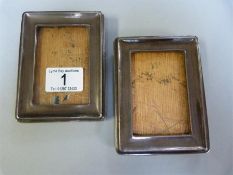 A pair of silver photo frames