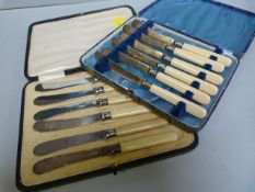 A cased set of silver banded butter knives and one other