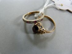 A cabochon garnet ring set in 9 ct gold (size L) and a diamond and ruby eternity ring set in 9 ct