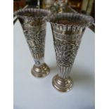 A pair of Hallmarked Silver weighted bud vases marked London 1895