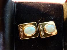 A pair of Gold cufflinks set with opal and four diamonds 18ct back and 9ct mount