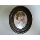 A portrait miniature of a lady, signed Petit