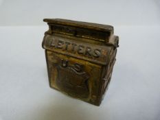 A Victorian era stamp box in the form of a U.S mail box, with badge to front depicting Washington