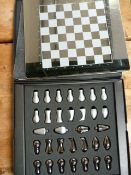 A modern chess set and board in case