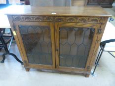 A leaded glass fronted display cabinet