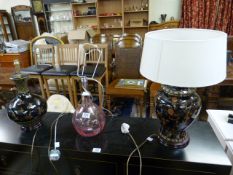Two similar oriental design lamps and a modern cranberry glass lamp