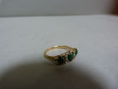 A Victorian three stone ring interspersed with diamonds set in yellow metal