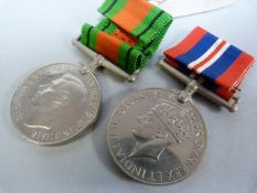 Two WW2 medals- The Defence medal and the War medal in a box addressed to G T Dunn