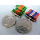 Two WW2 medals- The Defence medal and the War medal in a box addressed to G T Dunn