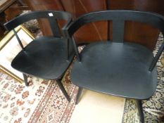 A pair of black lounge chairs