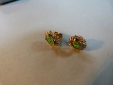 A pair of black opal earrings set in 9ct gold
