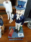 A Cast iron money box modelled as George Washington and an Uncle Sam reproduction cast iron money