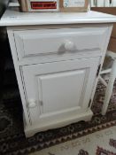 A pair of white painted bedside tables