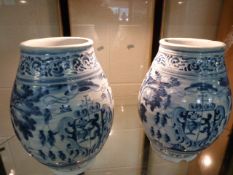 A pair of Delft apothecary jars, possibly 18th century, both depicting a coat of arms. One is