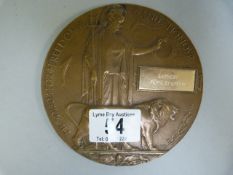 A WWII death plaque with modern metal name tag attached