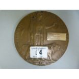 A WWII death plaque with modern metal name tag attached