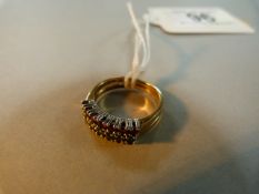 An 18ct gold ring with two bands of ruby's and emeralds- size J, total weight 3.6g