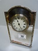 A silver plated mantle clock
