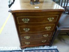 An inlaid chest of five drawers