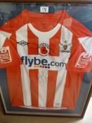 A framed and signed Exeter City football shirt