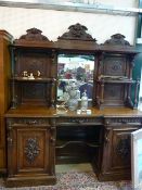 A large breakfront dresser with mirrored back