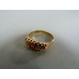 A ruby and diamond three stone ring set in 18ct gold- total weight 3.2g