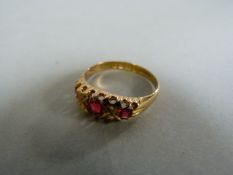 A ruby and diamond three stone ring set in 18ct gold- total weight 3.2g