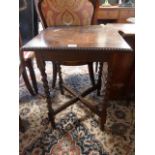 An oak side table on barley twist legs