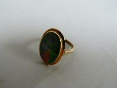A large black opal 9ct gold ring