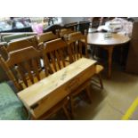 An extending dining table with 2 leaves and a set of six pine dining room chairs