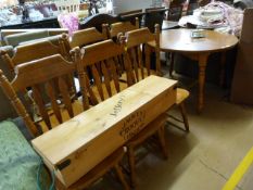 An extending dining table with 2 leaves and a set of six pine dining room chairs