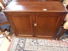 A mahogany two door cupboard