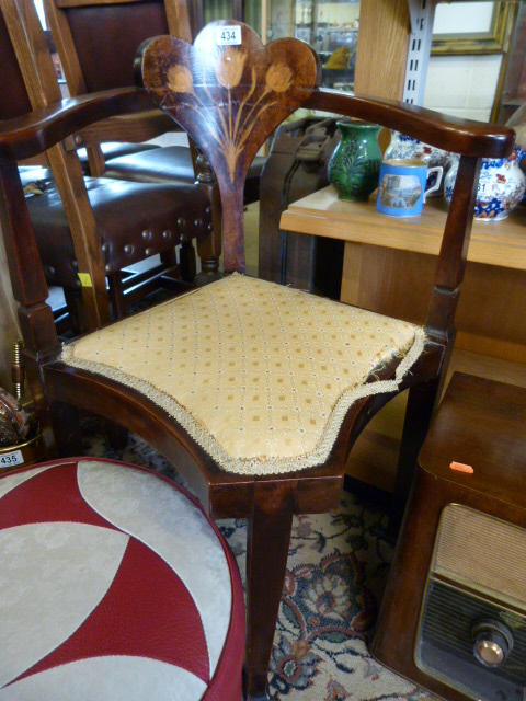 An Edwardian corner chair with inlaid floral decoration to back