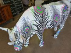 A life size fibreglass model of a cow, painted by Matthew Williamson- this cow was part of the Cow