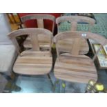 A Set of four light wood dining chairs