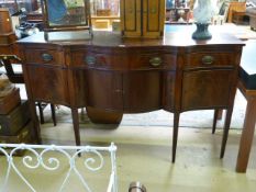 An inlaid serpentine sideboard