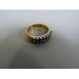 An 18ct gold ring with two bands of ruby's and emeralds- size J, total weight 3.6g