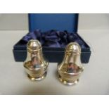 A pair of boxed hallmarked silver salt and pepper shakers